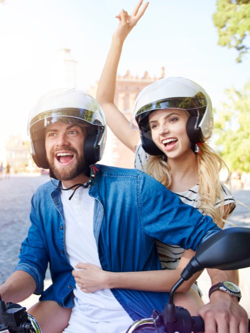 couple-riding-motorbike-wearing-helmets